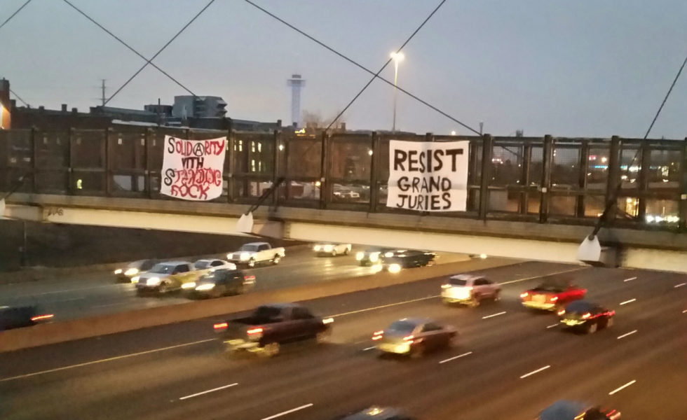 Denver, CO: Banner Drop in Solidarity with Standing Rock and GJ 